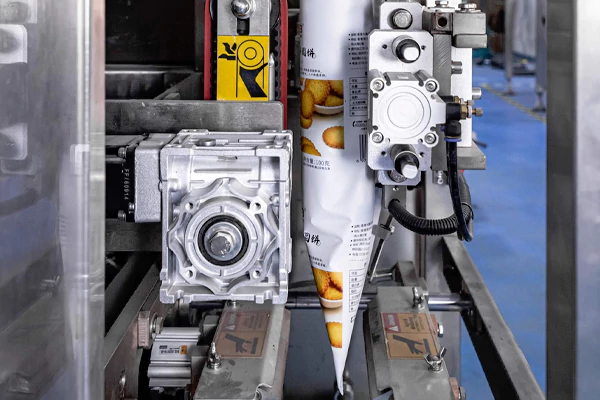 Automatic VFFS packaging machine running custom printed plastic food packaging roll film smoothly.